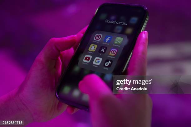 Man uses a mobile phone showing social media platforms' logos in Istanbul, Turkiye on June 08, 2024.