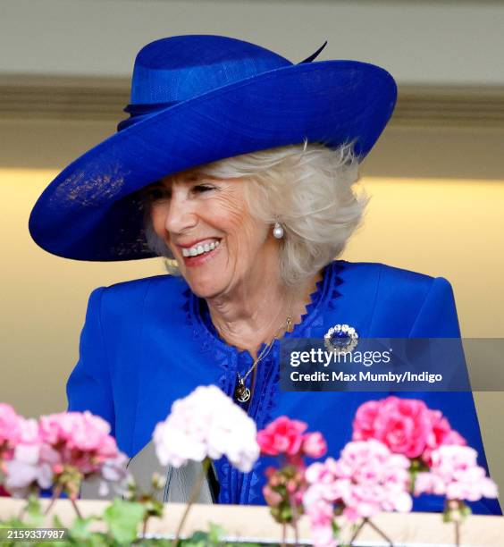 Queen Camilla watches the racing from the Royal Box as she attends day one of Royal Ascot 2024 at Ascot Racecourse on June 18, 2024 in Ascot, England.