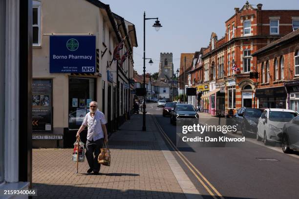 Man walks down the high street on June 26, 2024 in Walton-On-The-Naze, United Kingdom. As Nigel Farage returned to the helm of Reform UK ahead of the...