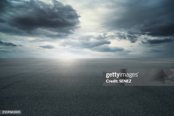 storm skies, road background - zementboden stock-fotos und bilder