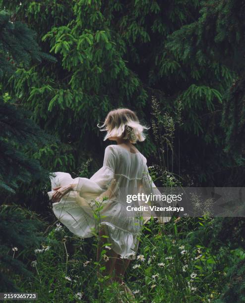 young beautiful woman in action at nature - green dress stock pictures, royalty-free photos & images