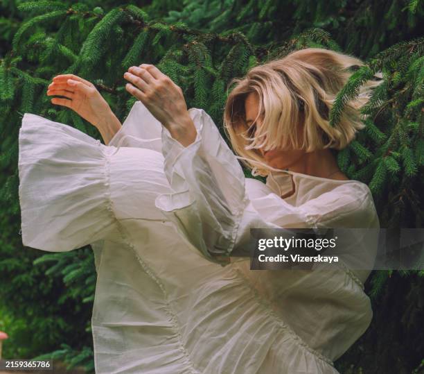 young beautiful woman in action at nature - white dress stock pictures, royalty-free photos & images