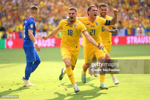 Razvan Marin celebrates scoring his team's first goal from the penalty spot with Nicolae Stanciu and Marius Marin of Romania during the UEFA EURO...