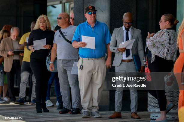 People line up as they wait for the JobNewsUSA.com South Florida Job Fair to open at the Amerant Bank Arena on June 26 in Sunrise, Florida. More than...