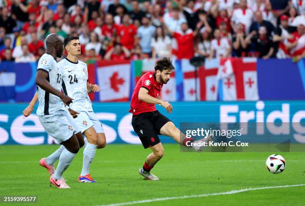 Khvicha Kvaratskhelia of Georgia scores his team's first goal during the UEFA EURO 2024 group stage match between Georgia and Portugal at Arena...