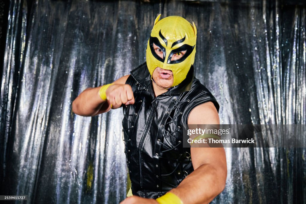 Medium shot posing luchador back stage before lucha libre match