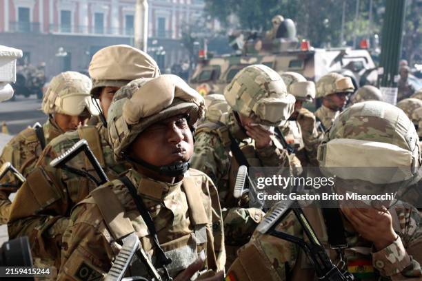 Military officers react to tear gas fired outside the presidential palace at Plaza Murillo on June 26, 2024 in La Paz, Bolivia. President of Bolivia...