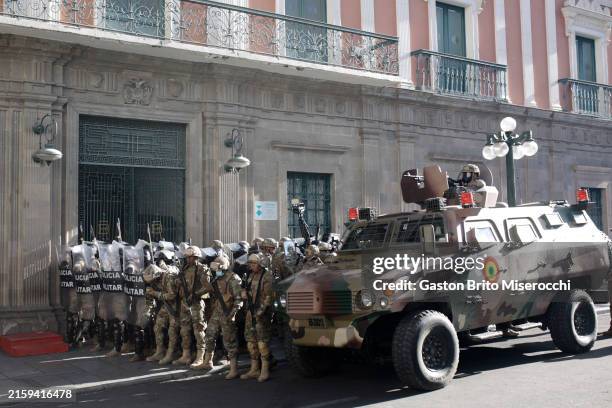 Military members stand guard with an armored truck outside the government palace at Plaza Murillo on June 26, 2024 in La Paz, Bolivia. President of...