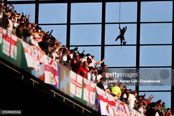 Silhouette of a statue of a window cleaner is seen on the side of the West Stand of the Cologne Stadium during the UEFA EURO 2024 group stage match...