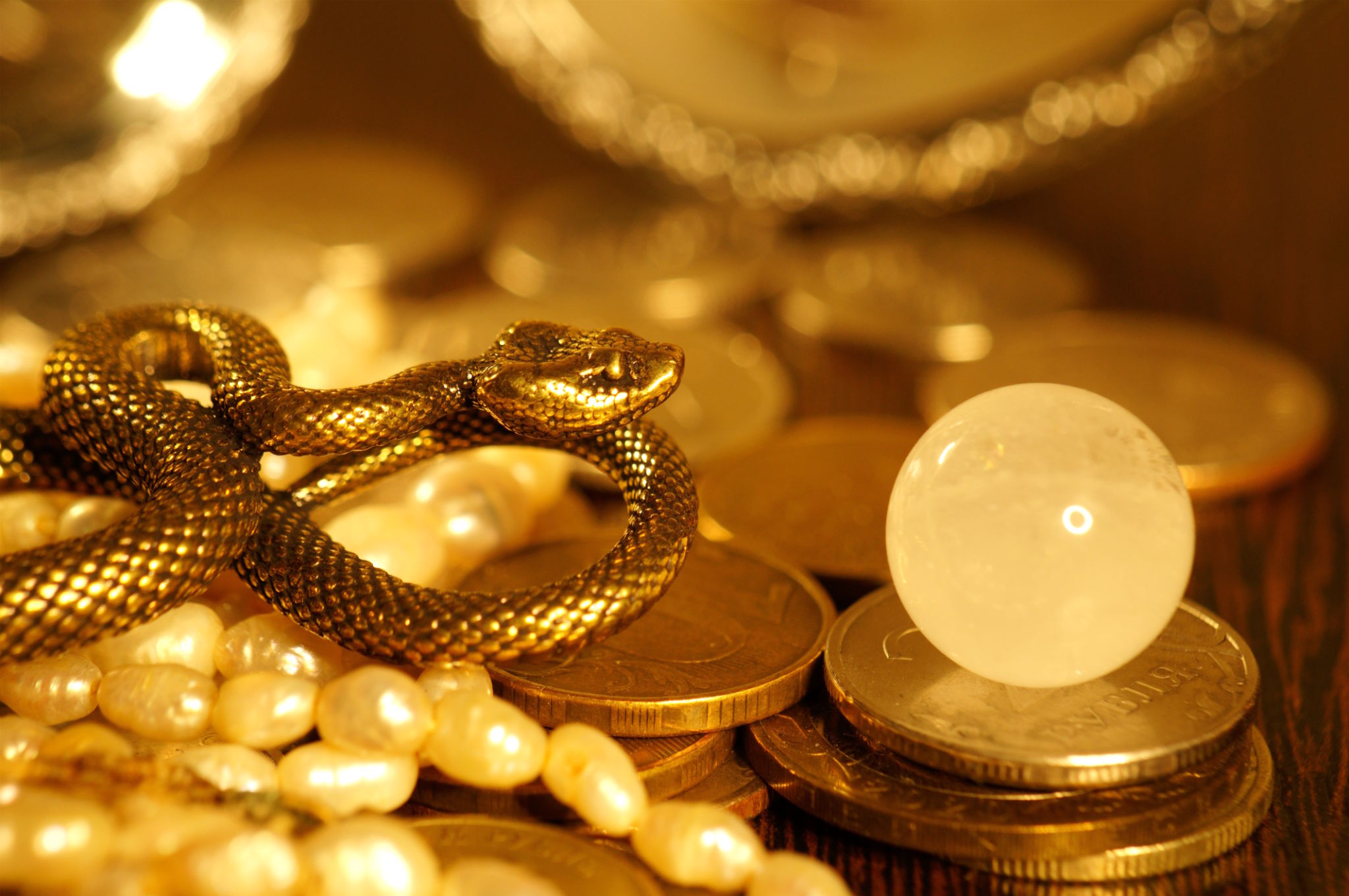 A snake statuette with coins. A snake statuette with coins.
