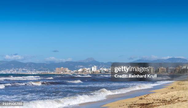 beach of bahia de palma against clear sky - palma beach stock pictures, royalty-free photos & images