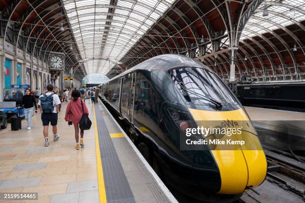 Great Western Railway train stopped at London Paddington railway station train shed which dates from 1854 during Victorian times and was designed by...