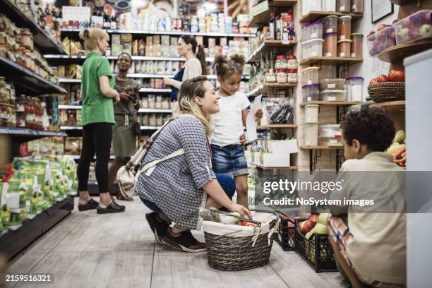 grocery shopping with family during daytime - overloaded shopping cart stock pictures, royalty-free photos & images