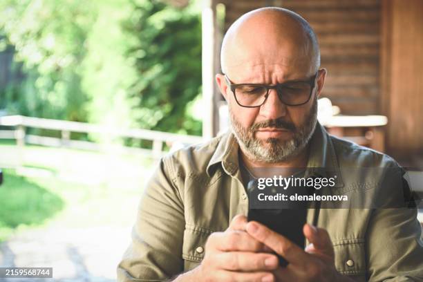 mature adult man with mobile phone - prevention stock pictures, royalty-free photos & images