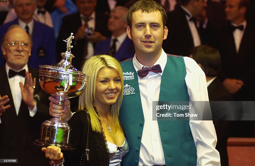 Mark Williams of Wales celebrates victory by posing with the trophy and his girlfriend Jo Dent