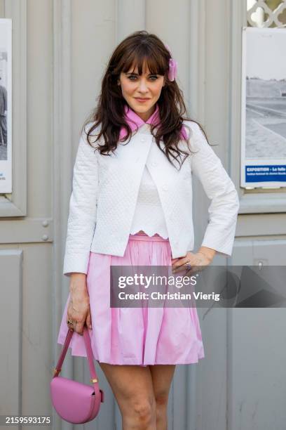 Zooey Deschanel wears pink skirt, white jacket, bag outside Patou during the Haute Couture Fall/Winter 2024/2025 as part of Paris Fashion Week on...