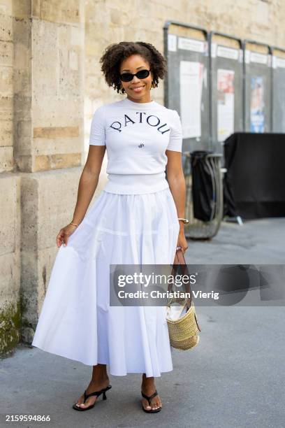 Ellie Delphine wears white shirt with logo print, skirt, basket bag outside Patou during the Haute Couture Fall/Winter 2024/2025 as part of Paris...