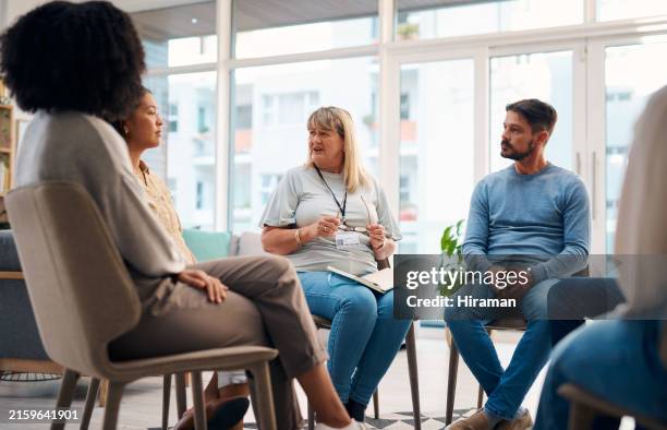 a diverse group of individuals seated in a circle, engaging in a support group meeting. the image portrays connection, communication, and emotional support in a bright, welcoming environment. - participant stock pictures, royalty-free photos & images