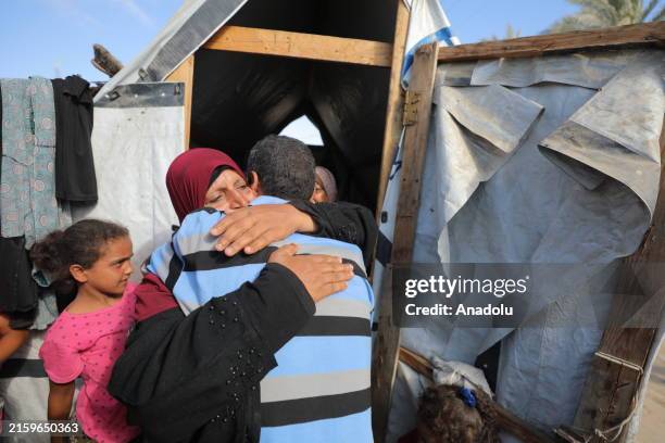 Palestinian Faraj Samouni catches up with his family in their makeshift tent after being released by the Israeli army in Deir al Balah, Gaza on July...