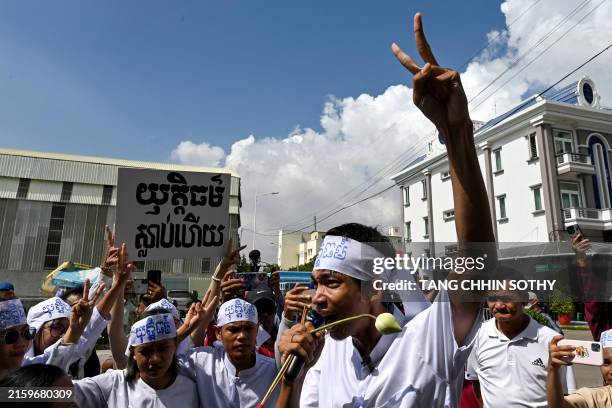 Cambodian environmental activist Ly Chandraravuth gestures outside Phnom Penh municipal court during a verdict in Phnom Penh on July 2, 2024. A...