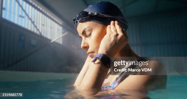 woman, swimmer and relax for sports in swimming pool with fitness training, workout and practice performance of competition. athlete, female person and ear blockage, protection and hygiene for health - zwemmer stockfoto's en -beelden