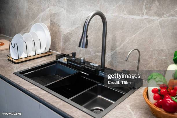 modern kitchen sink with black faucet - spülbecken stock-fotos und bilder