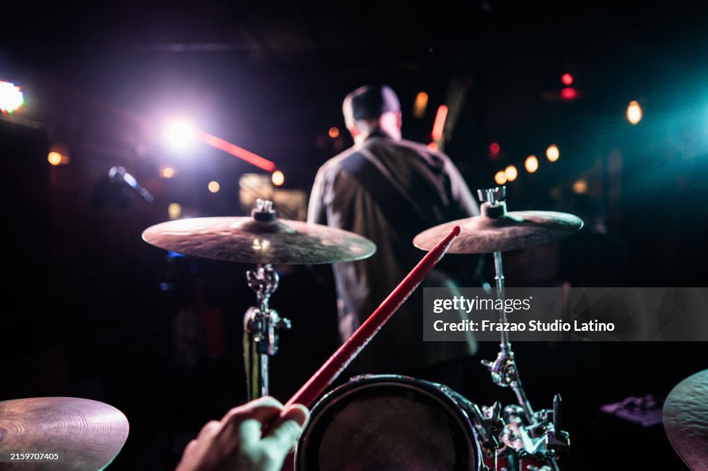 Drummer playing drum with band on nightclub - drummer point of view