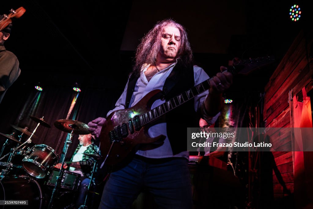 Mature man playing electric guitar on stage