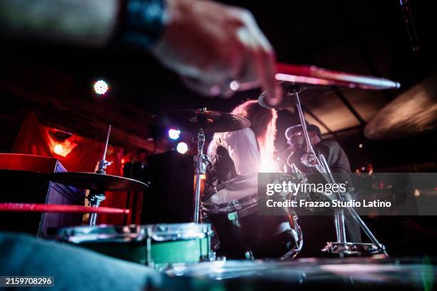 rock band playing and singing during show at night club - blues music stock pictures, royalty-free photos & images