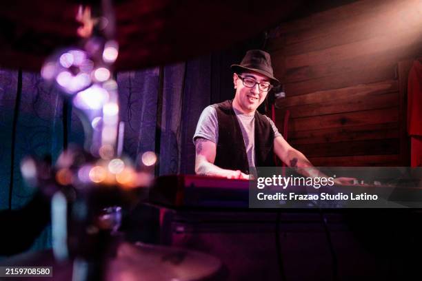 mid adult man playing synthesizer on live concert - pop musician stock pictures, royalty-free photos & images