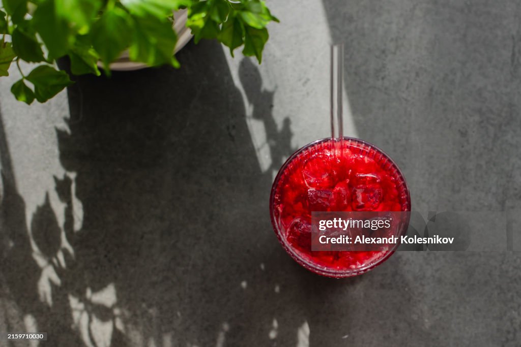 Summer refreshing non-alcoholic cocktails. Fresh raspberry beverage with sparkling water and ice cubes. High angle view with copy space