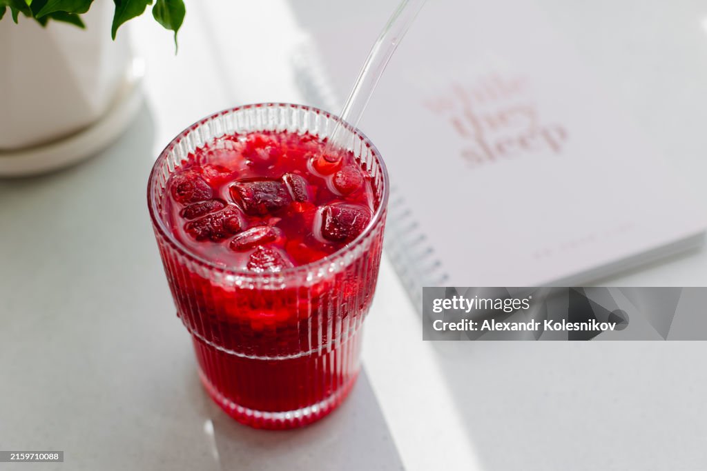 Spring or summer refreshing cocktail or mocktail with berries. Raspberry lemonade with glass straw
