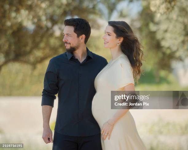 In this handout photo provided by the Royal Jordanian Court, and released on June 28 Crown Prince Prince Hussein of Jordan appears with his wife...