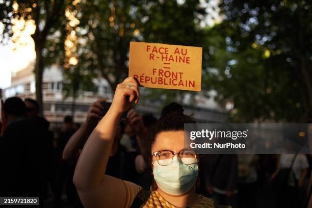 Woman is holding a placard reading 'To confront the R-Hate: Republican front'. A spontaneous gathering and march are taking place in Toulouse,...