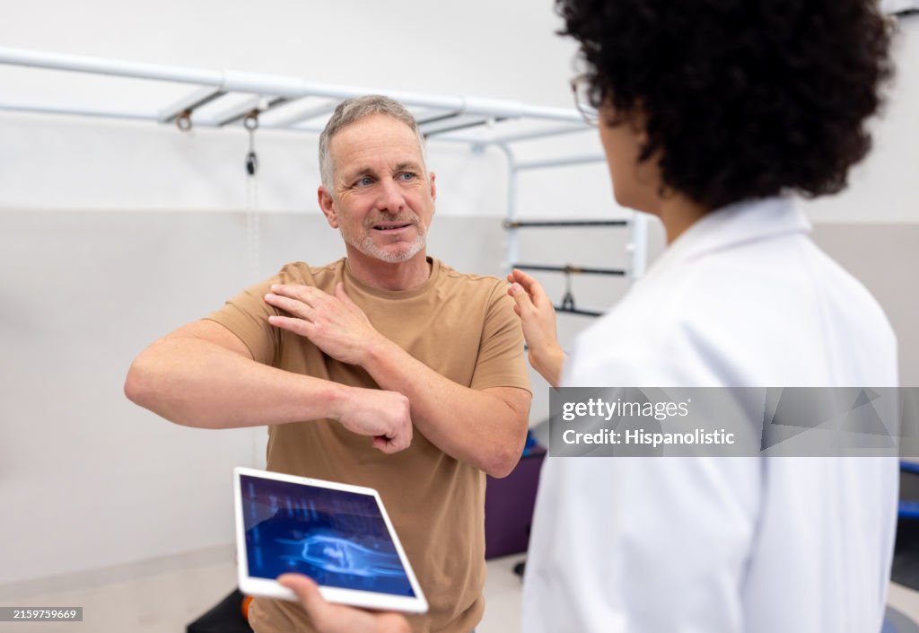 Patient talking to an orthopedist about pain in his shoulder