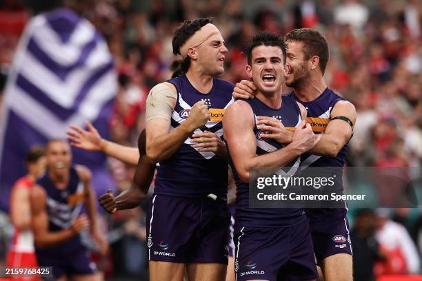 Jordan Clark of the Dockers, Andrew Brayshaw of the Dockers and Sam Switkowski of the Dockers celebrate winning the round 16 AFL match between Sydney...