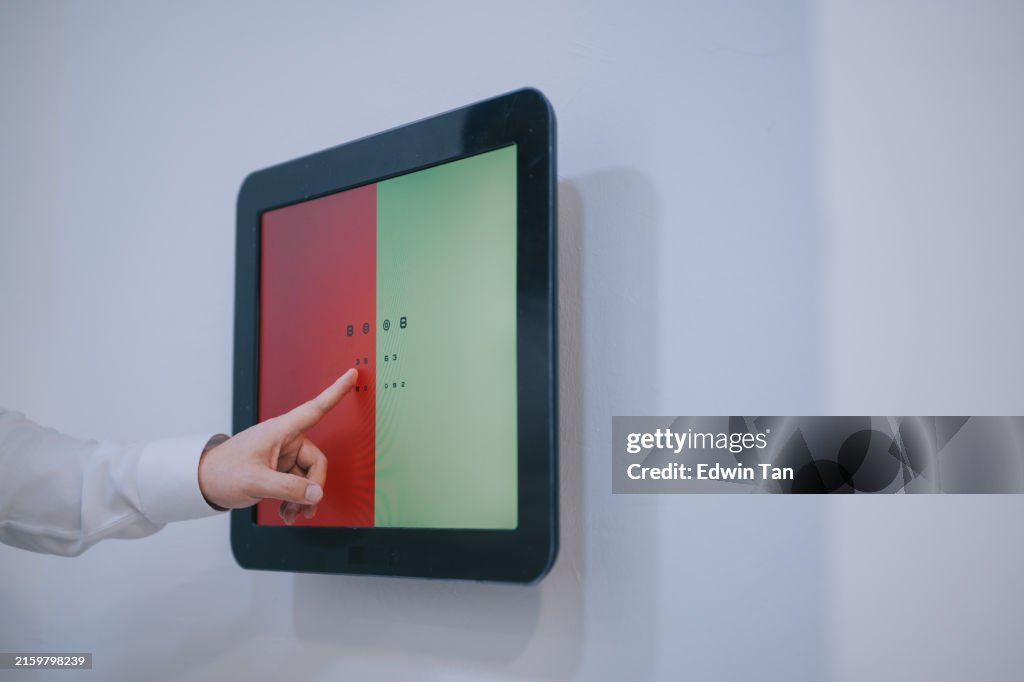 Hand pointing Eye chart with numbers and color vision test for examination in clinical setting