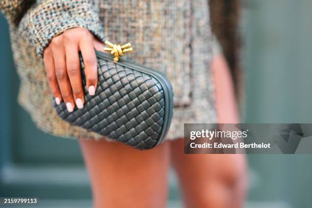 Eva Apio wears a dark green Bottega Veneta with gold knot leather handbag, outside Wooyoungmi, during the Paris Fashion Week Menswear Spring/Summer...