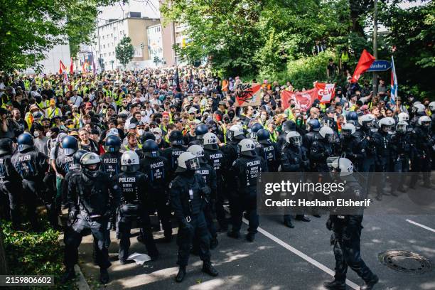 Policemen stand guard as protesters seek to block a street leading to the venue of the federal party congress of the far-right Alternative for...