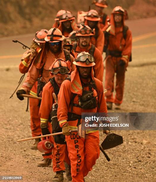 Inmate firefighters work the scene during the Thompson fire in Oroville, California, on July 2, 2024. A heatwave is sending temperatures soaring...
