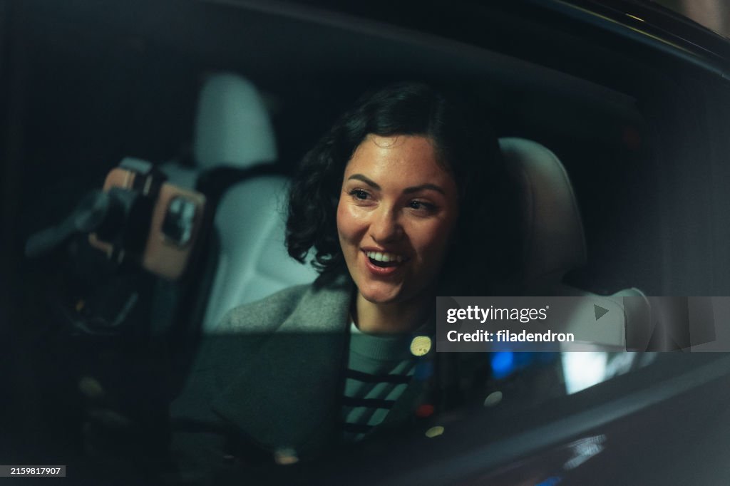 Smiling vlogger recording a video in car
