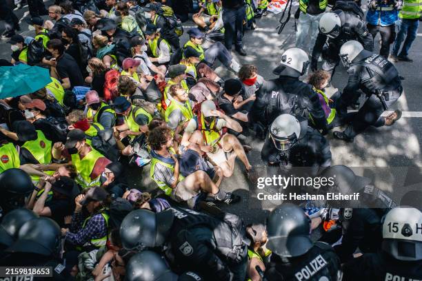 Police try to remove protesters seeking to block a street leading to the venue of the federal party congress of the far-right Alternative for Germany...