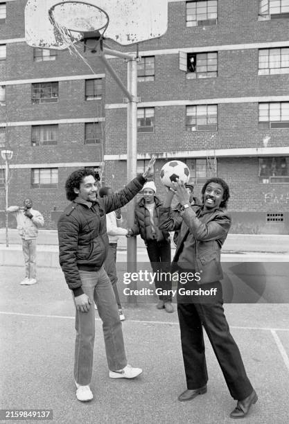 View of R&B, Disco, & Funk musician Robert 'Kool' Bell , a founding member of the group Kool & the Gang, as he plays basketball court with several...