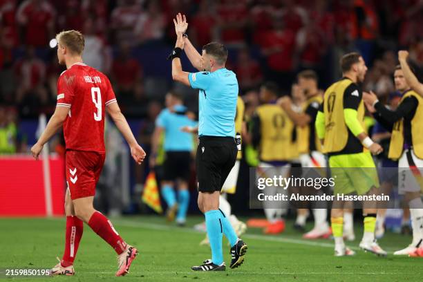 Referee Michael Oliver gestures for a handball which results in a penalty being awarded during the UEFA EURO 2024 round of 16 match between Germany...