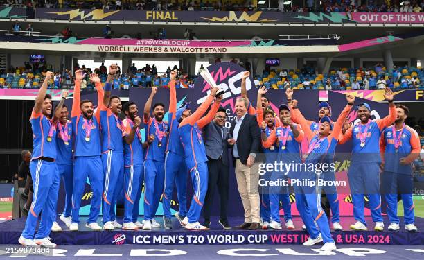 Rohit Sharma of India lifts the trophy after receiving it from Jay Shah of the BCCI and Greg Barclay of the ICC after India won the ICC Men's T20...