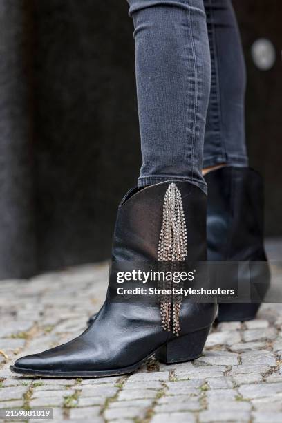 Anna von Schilcher, wearing a black slim jeans by JBrand and Cowboy booties with smal lateral chains by Schutz Brasil, seen during the Berlin Fashion...