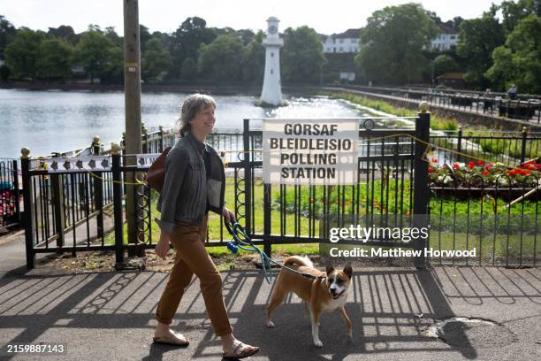 Woman walks past Roath Park polling station with her dog on July 4, 2024 in Cardiff, United Kingdom. Voters in 650 constituencies across the UK are...