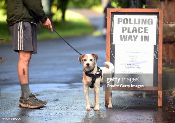 People arrive to cast their votes during the general election at Pollokshields Burgh Hall on July 4, 2024 in Glasgow, United Kingdom. Voters in 650...