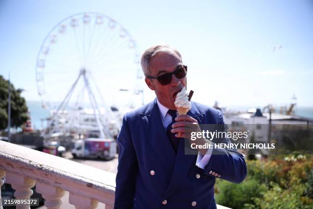Reform UK leader Nigel Farage eats a 99 Flake ice cream in Clacton-on-Sea, eastern England, on July 4, 2024 as Britain holds a general election.