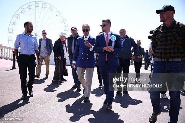 Reform UK leader Nigel Farage walks with Reform UK Chief of Staff, Dan Jukes in Clacton-on-Sea, eastern England, on July 4, 2024 as Britain holds a...